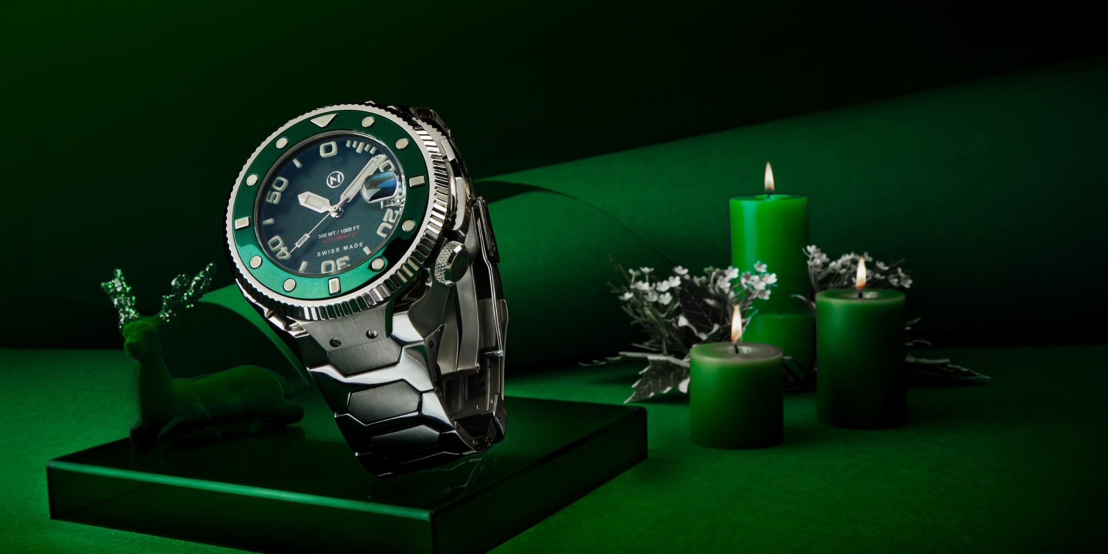 Green wristwatch on a dark green background with candles