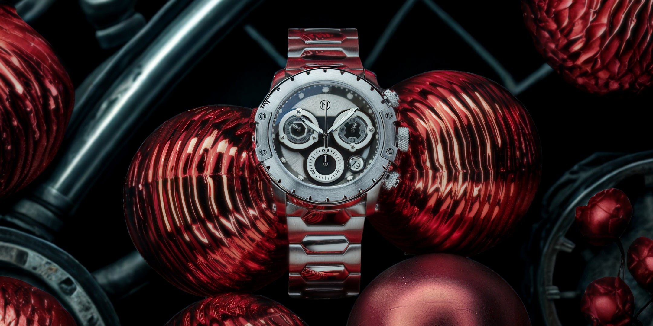 Silver watch with red accents on a dark background