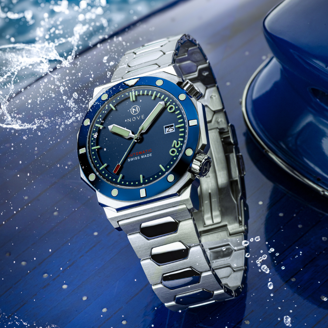 Stainless steel watch with blue bezel on the back of a boat